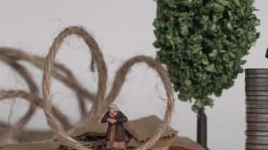 The concept of the gap between rich and poor. Business concept with piles of coins and miniature people.