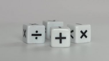 Four white dice with mathematical math symbols. Business concept with miniature with mathematical symbols.