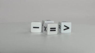 Four white dice with mathematical math symbols. Business concept with miniature.