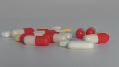 Various kinds of medicine and a white plastic bottle. The concept of caution when taking drugs.