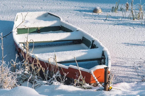 五彩斑斓的木船停泊在冰封的湖面上 湖面积雪覆盖着芦苇 — 图库照片