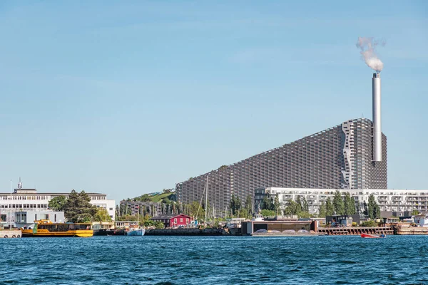 Amager Bakke, Slope or Copenhill, incineration plant, heat and power waste-to-energy plant and recreational facility in the district of Amager, Copenhagen, Denmark, with modern buildings and boats