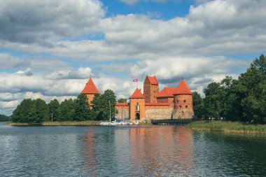 Medieval castle of Trakai, Vilnius, Lithuania, Eastern Europe, surrounded by beautiful lakes and nature in summer with water lilies and wooden bridge