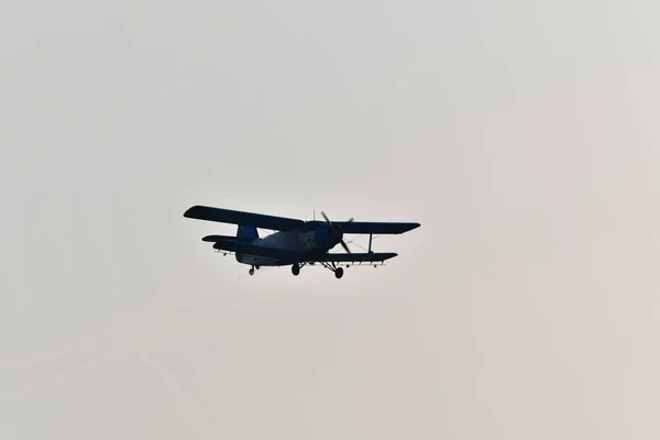 通用飞机是一种双翼飞机 主要用于农业中的通用飞机 以推广低空飞行的农用化肥或杀虫剂 并发射运动降落伞 — 图库照片