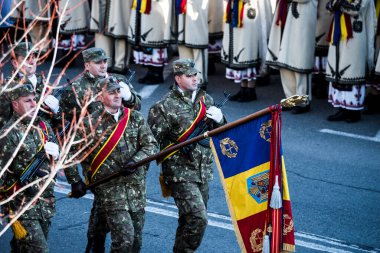 Romanya 'nın Targu-jiu' daki ulusal günü, gala üniformaları ve otomatik silah ve maskeleme kıyafetleriyle donatılmış Romen kara kuvvetleri askerleriyle geçit töreni düzenledi.