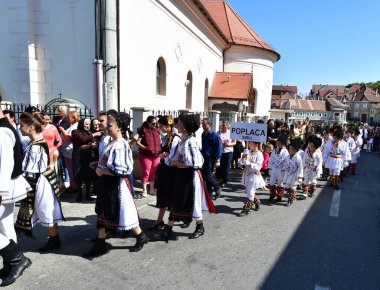 Sibiu Çayırı 'ndaki erkekler ve kızlar pastoral kostümler içinde yuvarlak kumaş şapkalar, etekli bir gömlek, pantolon, geniş bir deri kemer, göğüs ve kızlar beyaz bir fular, yakalı bir gömlek ve üç renkli bir kemer giyerler.