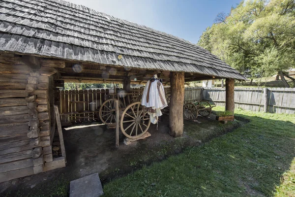 stock image Sura at the woods of Sibiu is an annex of a house or farm where cars,tools,implements, fodder and animals are kept,having function of a workshop,with workbenches,being built of wood,with large gates covered with shingles