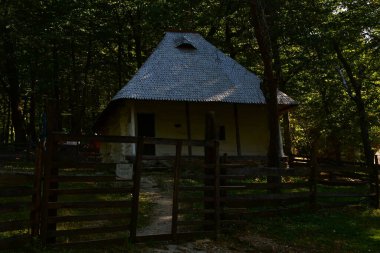 Geleneksel Romen tarzında ev, basitlik ve alçakgönüllülük, fayda ve doğal malzemeler, katı mimari, doğayla ilişkili olarak yapılmış, kapı eşiği kısa, pencereler küçük