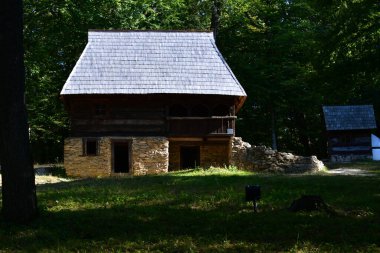 Geleneksel Romen tarzında ev, basitlik ve alçakgönüllülük, fayda ve doğal malzemeler, katı mimari, doğayla ilişkili olarak yapılmış, kapı eşiği kısa, pencereler küçük