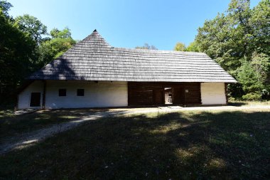 Geleneksel Romen tarzında ev, basitlik ve alçakgönüllülük, fayda ve doğal malzemeler, katı mimari, doğayla ilişkili olarak yapılmış, kapı eşiği kısa, pencereler küçük