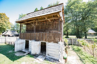 Ranza iki odalı bir yataktır, meşe sütunları, kalas için, iki sudaki kiremitli çatı.