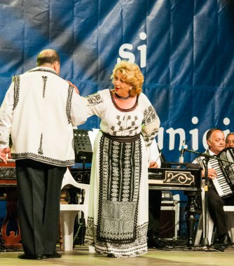 TARGU JIU, ROMANIA, MAYIS 25, 2018 GORJA Halk kostümlü sanatçılar Kadınlar için takım elbise bel, kalça ve ön, ve erkekler için gömlek, pantolon, yelek ve kemer.