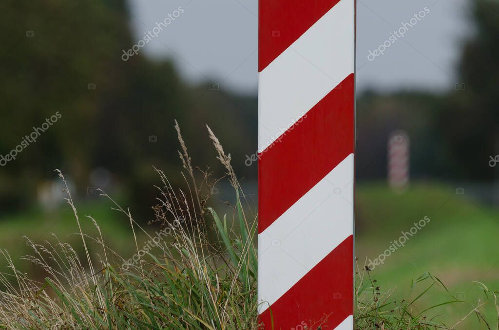STATE BORDER POST - The Polish border is marked with posts in national colors