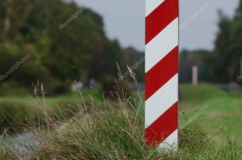 STATE BORDER POST - The Polish border is marked with posts in national colors