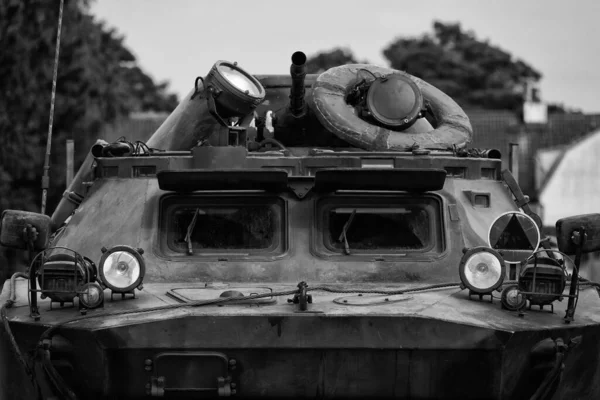 COMBAT RECONNAISSANCE-PATROL VEHICLE - A camouflage scout on a country road