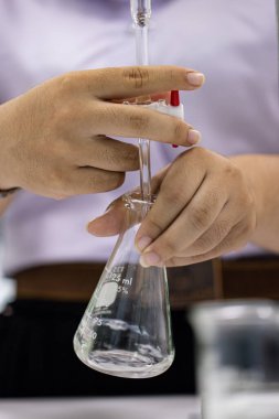 Scientist working Titration technique in the laboratory.