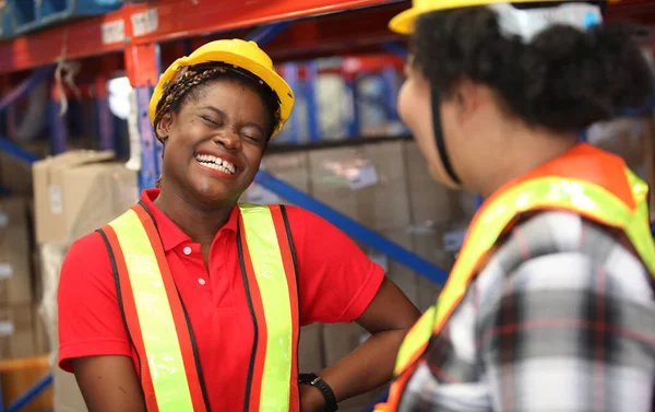 Portrait of people warehouse , they happy and  working at The Warehouse. Storehouse area, Shipment.  warehouse worker unloading pallet goods in warehouse