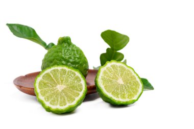 Isolated bergamot fruit. Fresh bergamot fruit with cut in half in wood plate on white background. clipping path.