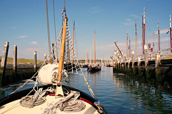Traditional sailing yacht runs tidal harbor