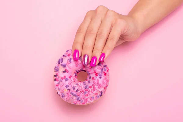 Female Hand Pink Manicure Nails Holding Sweet Strawberry Donut Royalty Free Stock Images
