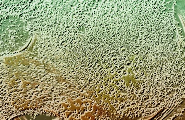 Parlak damlalı soyut bir arkaplan. Maddenin taklit edilmesi.