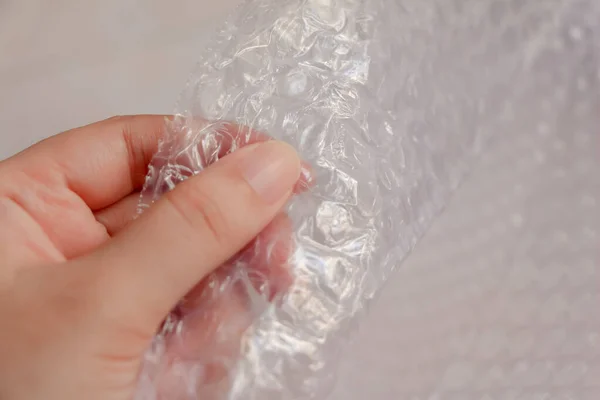 Woman play with bubble wrap to relieve stress