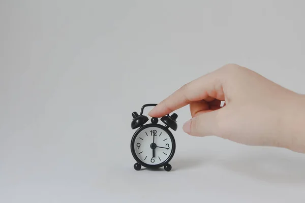 Hand Holding Black Alarm Clock White Background — ストック写真