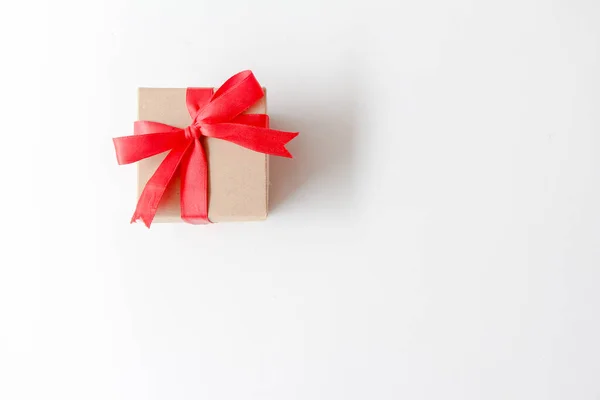 Brown Paper Gift Box Red Ribbon White Background Copy Space — Stock Fotó