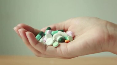 Woman holding pills in hand. Woman suicide by taking overdose medicines.Young woman is major depressive disorder.