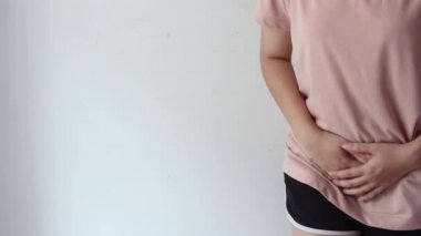 Kadın elleri kasıklarına baskı yapıyor, genç bir kadının karın ağrısı, jinekolojik veya tıbbi sorunlar kavramı.,