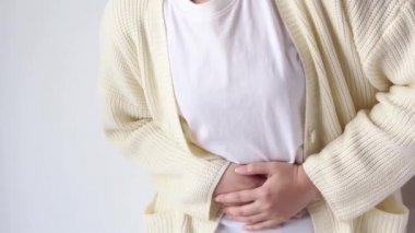 woman suffering from stomach ache, holding belly, feeling abdominal or menstrual pain or belly abdominal, diarrhea