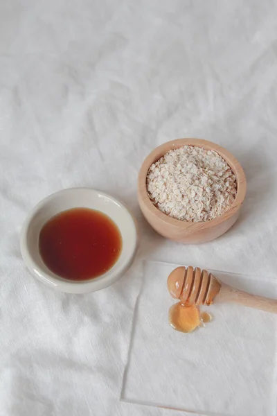 Natural ingredients for homemade face mask, oat and honey on white background, beauty skincare product concept,