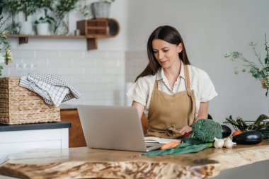 sebze yemek sırasında dizüstü kullanan kadın