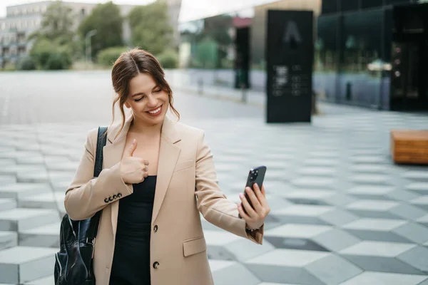 Happy woman using mobile app on smartphone to make video call, waving and greeting friends or family, talking on video call, staying connected at a distance. High quality photo
