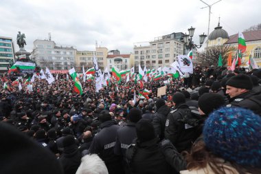 Sofia, Bulgaria - January 12, 2022: Police officers resist people during a protest against green certificate and vaccination against COVID-19 in fort of Bulgarian Parliament in Sofia. 