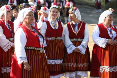Koprivshtica, Bulgaria - August 6, 2022: People in traditional folk costume of The National Folklore Fair in Koprivshtica. The National Folklore Fair in Koprivshtica is entered in the UNESCO Register of the human intangible cultural heritage
