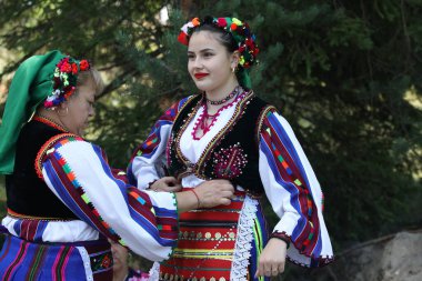 Koprivshtica, Bulgaria - August 6, 2022: People in traditional folk costume of The National Folklore Fair in Koprivshtica. The National Folklore Fair in Koprivshtica is entered in the UNESCO Register of the human intangible cultural heritage
