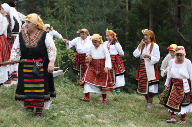 Koprivshtica, Bulgaria - August 6, 2022: People in traditional folk costume of The National Folklore Fair in Koprivshtica. The National Folklore Fair in Koprivshtica is entered in the UNESCO Register of the human intangible cultural heritage