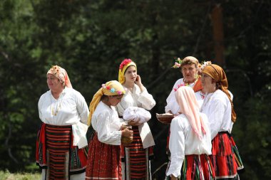 Koprivshtica, Bulgaria - August 6, 2022: People in traditional folk costume of The National Folklore Fair in Koprivshtica. The National Folklore Fair in Koprivshtica is entered in the UNESCO Register of the human intangible cultural heritage