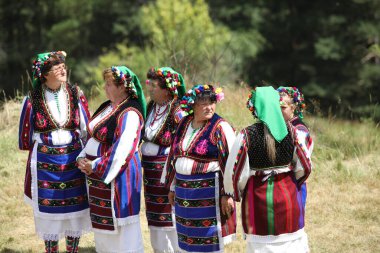 Koprivshtica, Bulgaria - August 6, 2022: People in traditional folk costume of The National Folklore Fair in Koprivshtica. The National Folklore Fair in Koprivshtica is entered in the UNESCO Register of the human intangible cultural heritage