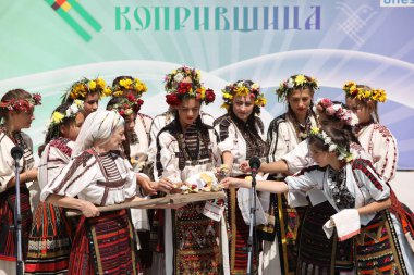 Koprivshtica, Bulgaria - August 6, 2022: People in traditional folk costume of The National Folklore Fair in Koprivshtica. The National Folklore Fair in Koprivshtica is entered in the UNESCO Register of the human intangible cultural heritage
