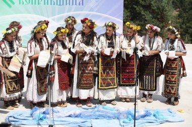 Koprivshtica, Bulgaria - August 6, 2022: People in traditional folk costume of The National Folklore Fair in Koprivshtica. The National Folklore Fair in Koprivshtica is entered in the UNESCO Register of the human intangible cultural heritage