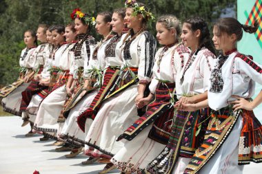 Koprivshtica, Bulgaria - August 6, 2022: People in traditional folk costume of The National Folklore Fair in Koprivshtica. The National Folklore Fair in Koprivshtica is entered in the UNESCO Register of the human intangible cultural heritage
