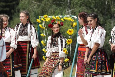 Koprivshtica, Bulgaria - August 6, 2022: People in traditional folk costume of The National Folklore Fair in Koprivshtica. The National Folklore Fair in Koprivshtica is entered in the UNESCO Register of the human intangible cultural heritage