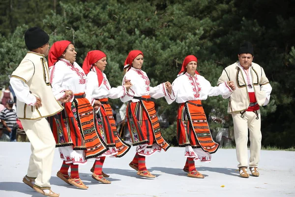Koprivshtica, Bulgaria - August 6, 2022: People in traditional folk costume of The National Folklore Fair in Koprivshtica. The National Folklore Fair in Koprivshtica is entered in the UNESCO Register of the human intangible cultural heritage