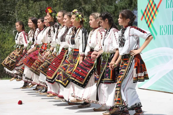 Koprivshtica, Bulgaria - August 6, 2022: People in traditional folk costume of The National Folklore Fair in Koprivshtica. The National Folklore Fair in Koprivshtica is entered in the UNESCO Register of the human intangible cultural heritage