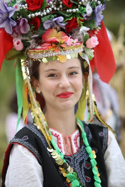 Koprivshtica, Bulgaria - August 6, 2022: People in traditional folk costume of The National Folklore Fair in Koprivshtica. The National Folklore Fair in Koprivshtica is entered in the UNESCO Register of the human intangible cultural heritage
