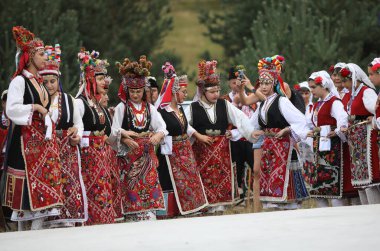Koprivshtica, Bulgaria - August 6, 2022: People in traditional folk costume of The National Folklore Fair in Koprivshtica. The National Folklore Fair in Koprivshtica is entered in the UNESCO Register of the human intangible cultural heritage