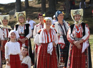 Koprivshtica, Bulgaria - August 6, 2022: People in traditional folk costume of The National Folklore Fair in Koprivshtica. The National Folklore Fair in Koprivshtica is entered in the UNESCO Register of the human intangible cultural heritage