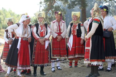 Koprivshtica, Bulgaria - August 6, 2022: People in traditional folk costume of The National Folklore Fair in Koprivshtica. The National Folklore Fair in Koprivshtica is entered in the UNESCO Register of the human intangible cultural heritage